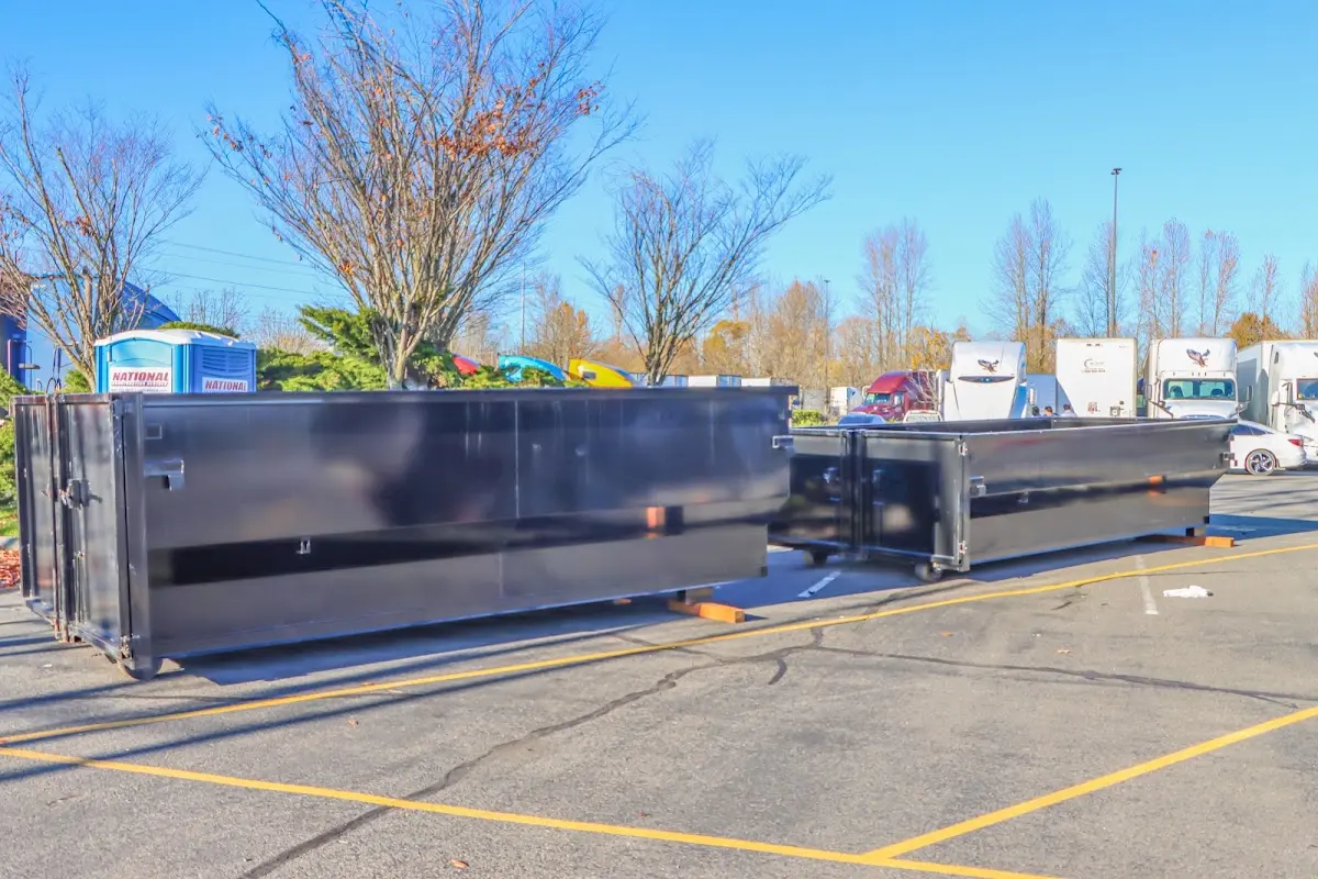 Professional dumpster rental service with roll-off container on residential driveway in Port Isabel